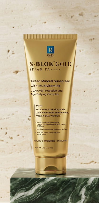 S-Blok Gold sunscreen tube on a marble surface with a beige background